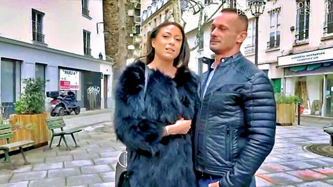 Sexy Asian babe in fur coat cuddles with bald hunk in leather jacket on Paris street