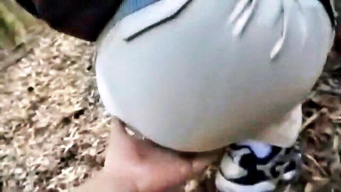 Man spanking huge pale ass cheeks of woman bent over outdoors with shorts pulled down