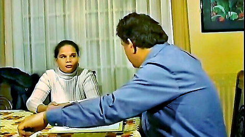 Mixed-race woman in white turtleneck sweater chatting intimately with man across dining table