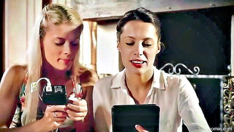 Sexy blonde and brunette babes intimately viewing phones in revealing tops