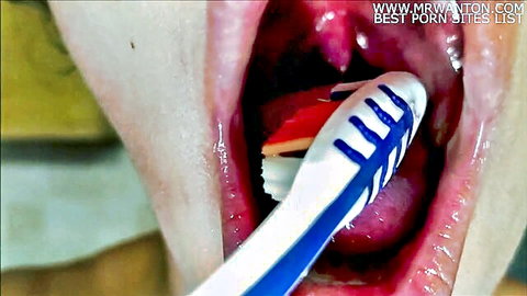 Close-up mouth fetish: wide open mouth with toothbrush on tongue, spit play