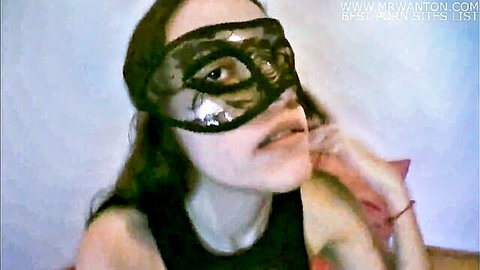 Masked brunette in seductive lace eye mask with parted lips
