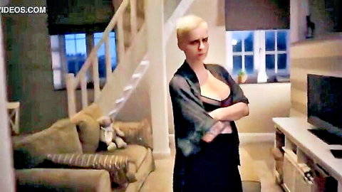 Mila Milan teases with big cleavage in open black robe, short blonde hair