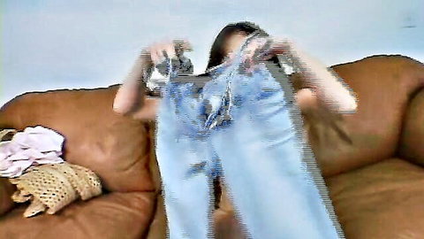 Liza Harper MILF holding jeans post-creampie, seductive pose on couch