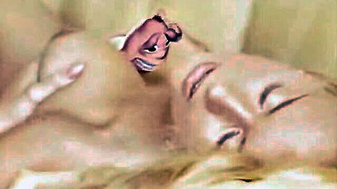 Blonde woman lying topless with cartoon hot dog peeking from cleavage