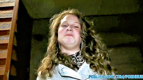 18-year-old gymnast in white coat posing in changing room, curly hair