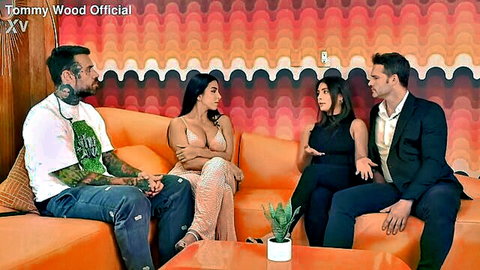 Tru Kait in low-cut gold dress with guests on Plug Talk interview