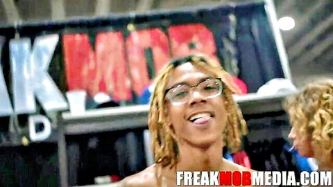 Playful black model with blonde dreads and glasses at Exxxotica Miami 2021