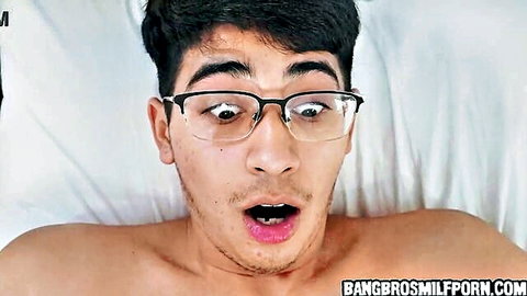 Surprised young stepson with glasses caught shirtless in bed by hot stepmom