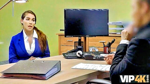 Brunette MILF in business suit at desk, office seduction scene
