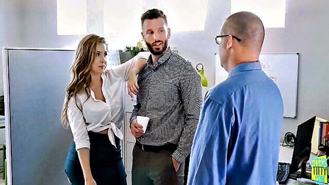 Lena Paul in steamy office chat with two colleagues, hinting at juicy reward