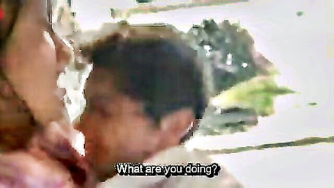 Asian woman questions man nuzzling her chest in intimate close-up