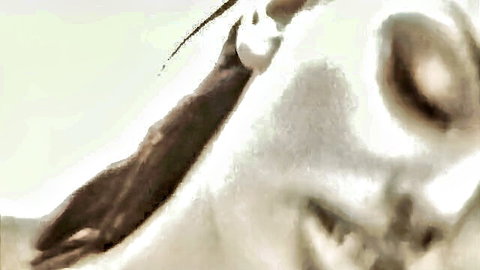 Black-and-white close-up of aroused woman's face in hardcore glamour PMV