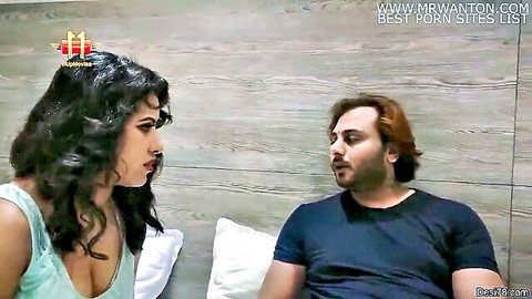 Indian couple in intimate talk, curvy woman in low-cut green tank top showing cleavage
