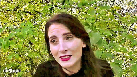 Brunette woman with red lips in outdoor cuckold video thumbnail