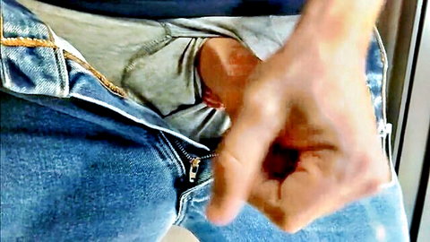 Man stroking erect cock through open jeans and underwear