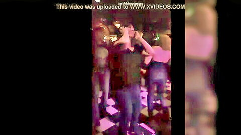 MILF flashing her boobs in a crowded concert club