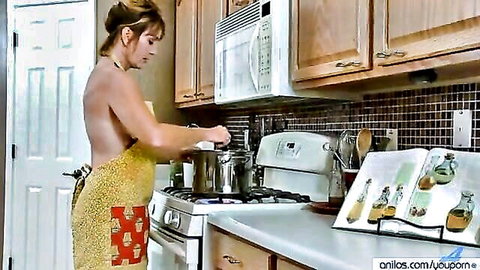 Mature brunette housewife in backless yellow apron cooking nude