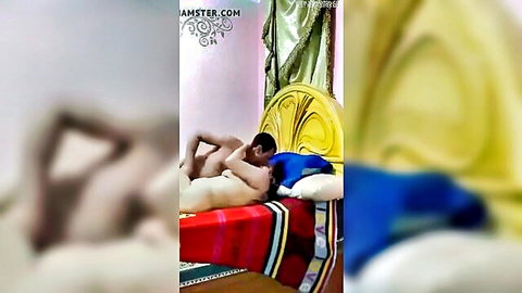 Arab MILF in nude embrace with man on bed, passionate couple intimacy