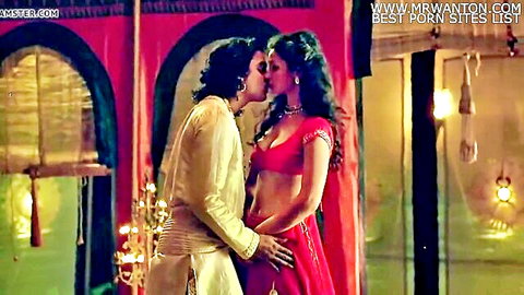 Indian couple passionately kissing with her big tits spilling from red saree blouse and his hand groping her ass