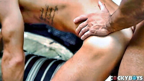 Muscular tanned hunk grips athletic dude's ass fucking him doggy style outdoors