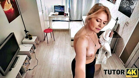 Blonde tutor topless after tea spill, holding wet shirt in quick sex scene