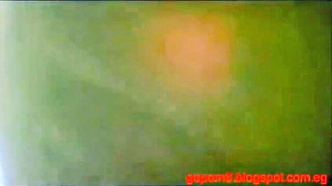 Blurry green abstract image with orange glow and Egyptian blog watermark.