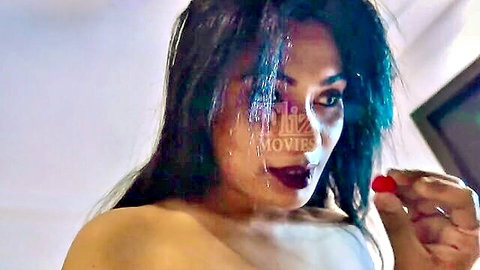 Seductive topless Indian woman with long dark hair teasing lips with red fruit in Jalwa web series EP1