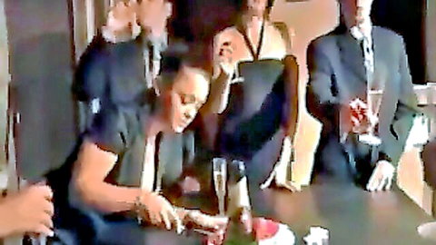 Elegant French swingers at party toasting champagne in sexy dresses and suits