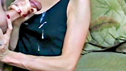 Woman giving intense handjob to big cock with cumshot on black tank top