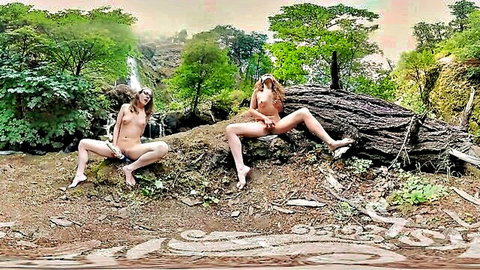 Two petite brunettes with small tits spread shaved pussies nude outdoors by forest waterfall
