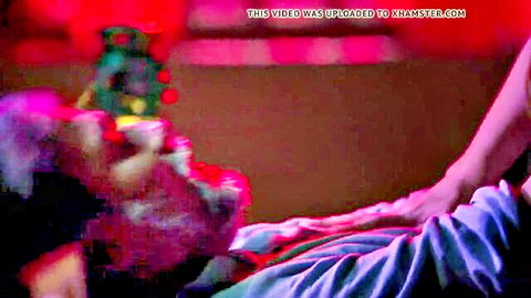 Blurry mature woman spreads legs fingering wet pussy on bed with Christmas tree backdrop