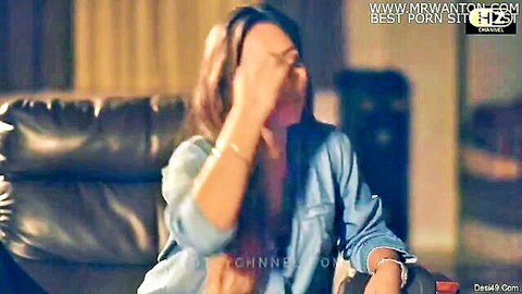 Desi woman in denim shirt, shy pose in SHRI Episode 2 straight lesbian play