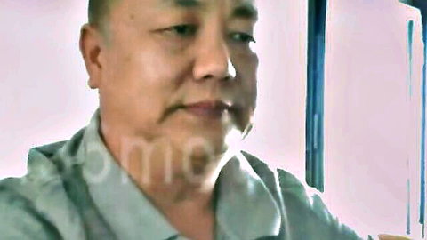 Mature Chinese man in casual shirt, smiling portrait