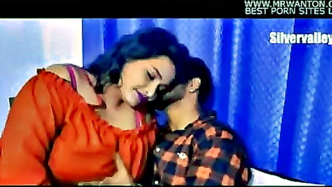 Busty Indian woman in red top kisses boyfriend's neck intimately