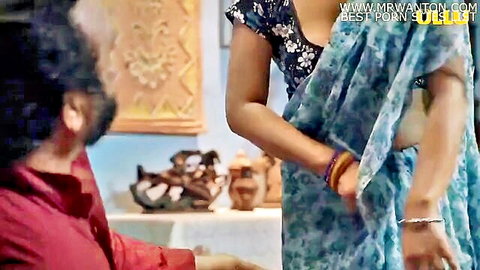 Indian woman in sheer blue saree exposing side boob with bearded man in red shirt