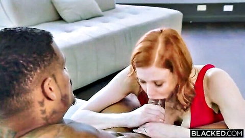 Curvy redhead MILF with huge tits sucks massive black cock in interracial blowjob on couch