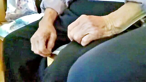 Close-up of elderly Chinese granny's wrinkled hands and arms in casual attire