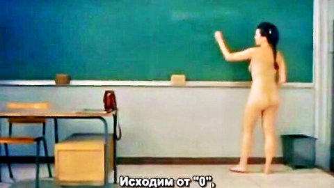 Nude Asian teacher writing on blackboard in classroom