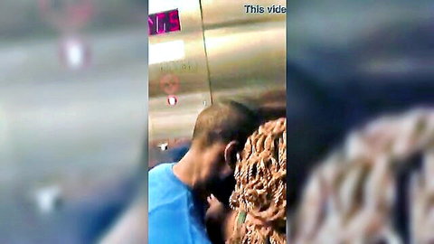 Ebony woman with braids passionately kissed on neck by man in public elevator
