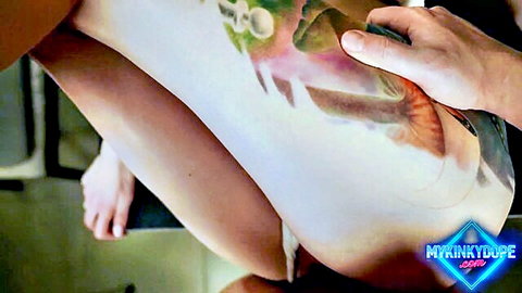 Tattooed woman’s thigh gripped in kinky upside down blowjob scene