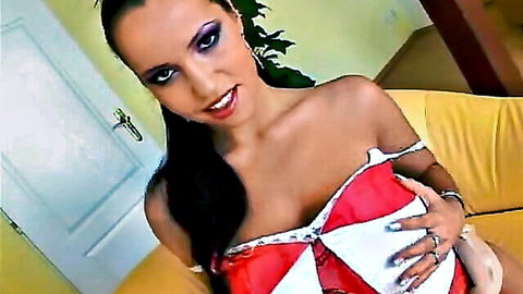 Laura Lion in red lingerie, smiling seductively with ponytail
