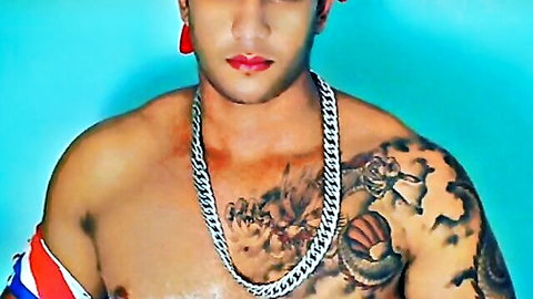 Shirtless muscular Asian man Diogo with dragon tattoos and gold chain