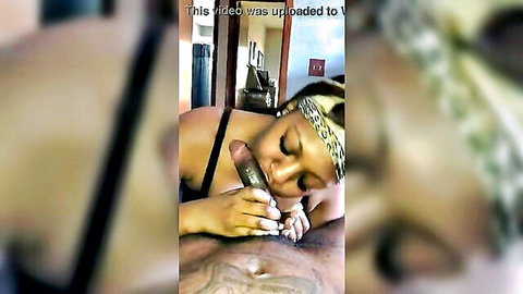Ebony BBW with headwrap grips thick black cock to her lips for messy blowjob.
