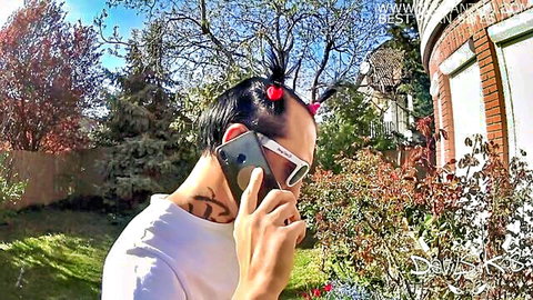 Sasha Rose in devil horns and sunglasses, outdoor phone call tease