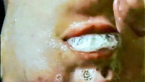Close-up of woman's mouth with cum dripping from deepthroat blowjob