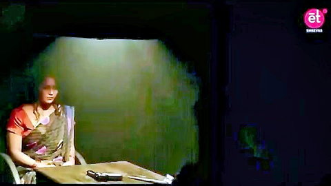 Seductive Indian woman in saree at table with gun in dramatic scene from The Lust