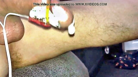 Man using TENS estim device for massive cumshot close-up
