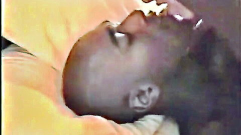 Black bald man sucking on woman's breast in intimate birthday surprise