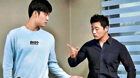 Two handsome Korean men in intense close-up conversation, one pointing finger at the other's face passionately